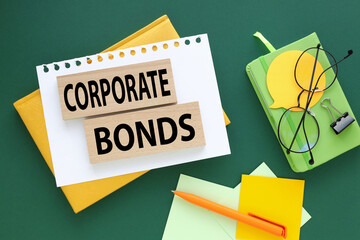 Wall Mural - CORPORATE BONDS text on wooden blocks. on a green background on a yellow notebook.