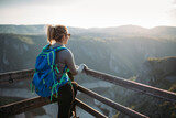 Fototapeta  - Young woman hiker at canyon viewpoint