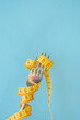 Bright yellow measuring tape on fork on a blue background. Diet concept
