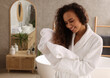 © New Africa - Beautiful African American woman drying hair with towel in bathroom