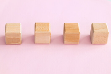 Wall Mural - Wooden cubes on yellow-pink background