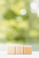 Canvas Print - Business concept - Abstract geometric real floating wooden cube on green summer background