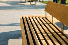 Wooden Bench In City Park On Sunny Morning, Closeup