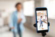 © Prostock-studio - Cheerful black woman filming dance video on cell phone