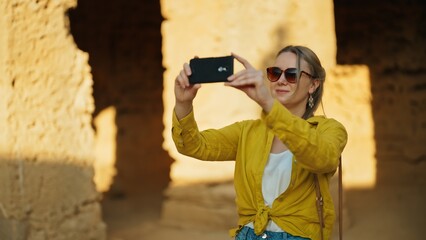 Poster - Woman shooting video via smartphone on excursion.