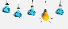 Brainstorming Concept With Crumpled Paper Light Bulbs - Flat Lay