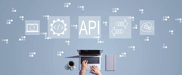 API - application programming interface concept with person working with a laptop