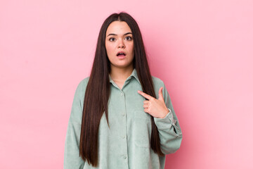 Wall Mural - young adult woman looking shocked and surprised with mouth wide open, pointing to self