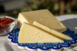 © barmalini - Spanish hard goat cheese served outdoor with membrillo jam with blue sea on background