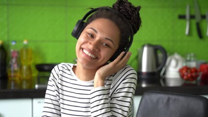 Wall Mural - close up of positive beautiful female listening to music in headphones at home