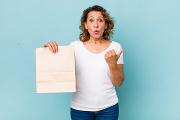 Wall Mural - middle age woman looking astonished in disbelief. take away concept