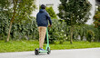 © Syda Productions - transport, safety and people and concept - young man in helmet riding electric scooter on city street