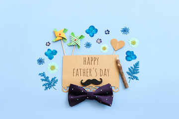 Wall Mural - Father's day concept. bow tie and funny moustache over blue background. top view, flat lay
