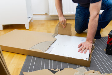 Professional Furniture Assembly Worker Assembles Shelf. Furniture assembly process. Assembling several pieces of furniture. DIY Assembling