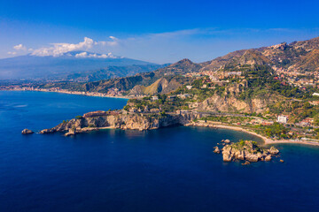 Wall Mural - Taormina is a city on the island of Sicily, Italy. Mount Etna over Taormina cityscape, Messina, Sicily. View of Taormina located in Metropolitan City of Messina, on east coast of Sicily island, Italy.