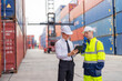 © Chatchawal - Container yard manager briefing work plan with the supervisor at container yard warehouse.
