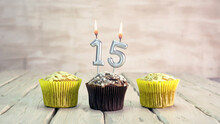Happy Birthday Muffins With Candles With The Number 15. Card Copy Space With Pies For Congratulations.