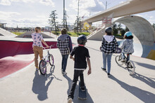 Multiethnic Skaters Walking Through Skatepark