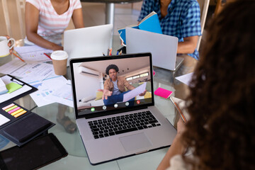 Sticker - African american angry businessman on video call talking to biracial female colleague in office