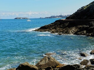 Dinard, France - August 2018 : Walking on the beach of Dinard on the Breton coast / manche. Overview of beautiful and large tourist houses and old fortifications