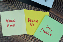 Concept Of Work Hard, Dream Big, Stay Positive Write On Sticky Notes Isolated On Wooden Table.