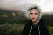 © Cavan Images - Wind Blown Blue Haired Teen Girl Outside In Nature