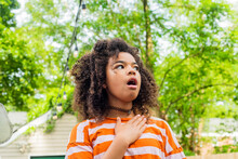 Child In Backyard Acting Surprised