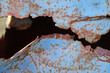 Fragment of rusty metal sheet. After many years of operation, corroded metal destroyed. rusty metal surface texture with holes metal corrosion. Selective focus.