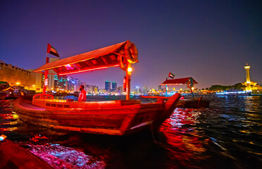 Canvas Print - Abra boats on Dubai Creek in bright lights, UAE