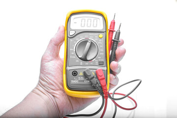 multimeter in hand on white background