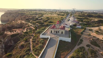 Wall Mural - Aerial view of Ponta da Piedade lighthouse in Lagos town, Algarve, Portugal