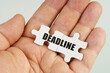 © Dzmitry - In the hand of a man are puzzles with the inscription - DEADLINE