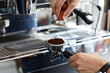 barista's hands temper coffee against the background of a coffee machine