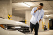 © Home-stock - Young man stands near a scratched car and calls a car service.