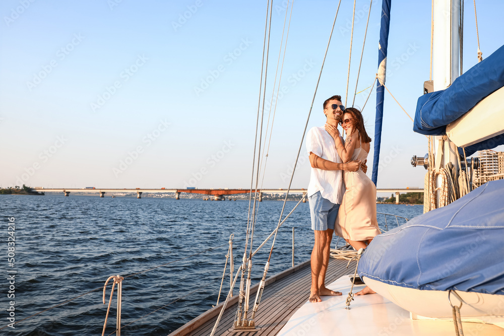 Happy young couple resting on yacht