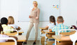© JackF - Portrait of female teacher lecturing to children at elementary school