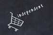 Chalk drawing of shopping cart and word independent on black chalboard. Concept of globalization and mass consuming