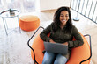 © Prostock-studio - Portrait of smiling black woman using laptop at home