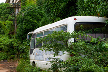 An Old Minibus Passenger Car Parked In An Abandoned Industrial Park