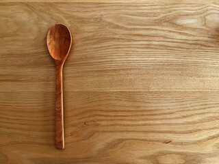 big wooden spoon on wooden background