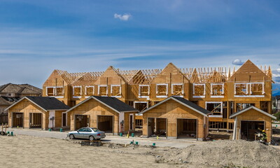 Wall Mural - Construction of a new wooden building in a residential area of Richmond City. Construction of the house at the stage of the foundation laid and the beginning of the framing works on the walls