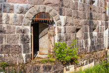Old Rusty Iron Gate In A Fortified Wall