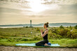 © bevisphoto - a woman is doing yoga in the morning