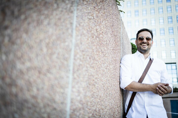 Wall Mural - Business man standing by the wall. Posing in white shirt Copy space