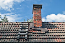 Old Chimney With Wooden Ladder On Roof
