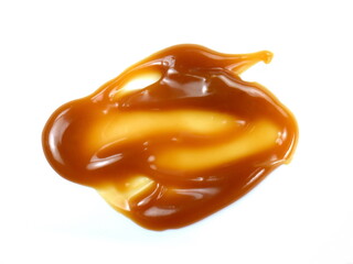 Canvas Print - Sweet caramel sauce isolated on white background close up. Golden Butterscotch toffee caramel liquid. Melted caramel sauce drop.