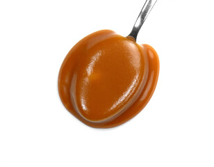 Canvas Print - Sweet caramel sauce in a metal spoon isolated on white background close up. Golden Butterscotch toffee caramel liquid. Melted caramel sauce drop.