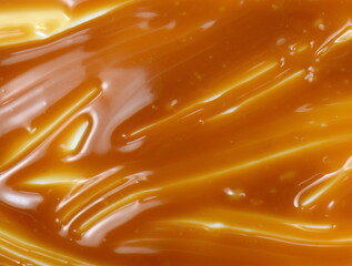 Canvas Print - Sweet caramel sauce drop background close up. Golden Butterscotch toffee caramel liquid. 