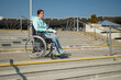 © Михаил Решетников - A caucasian woman in a wheelchair cannot go down stairs without a ramp. Hard to access environment.