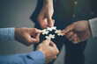 Leinwandbild Motiv Concept of teamwork and partnership. Hands join puzzle pieces in the office. business people putting the jigsaws team together.Charity, volunteer. Unity, team business.